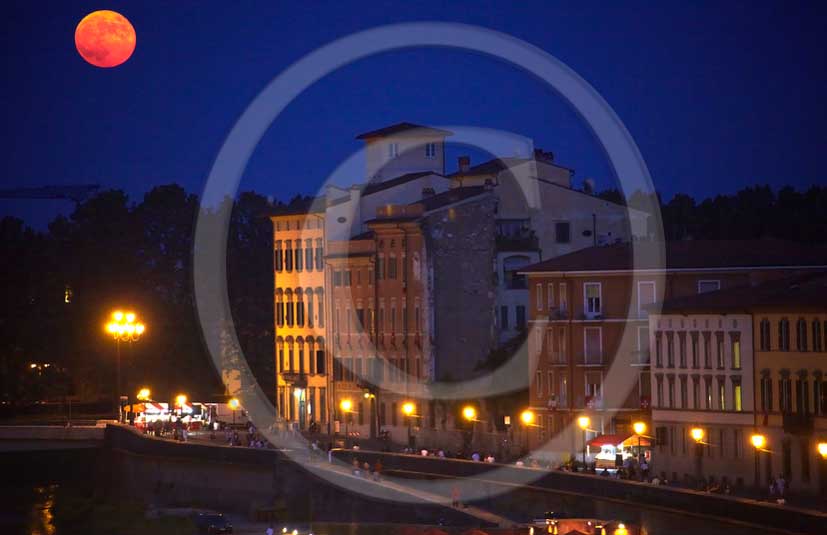 2011 - Night view with red moon of house and buildings in Lungarni of Pisa town.